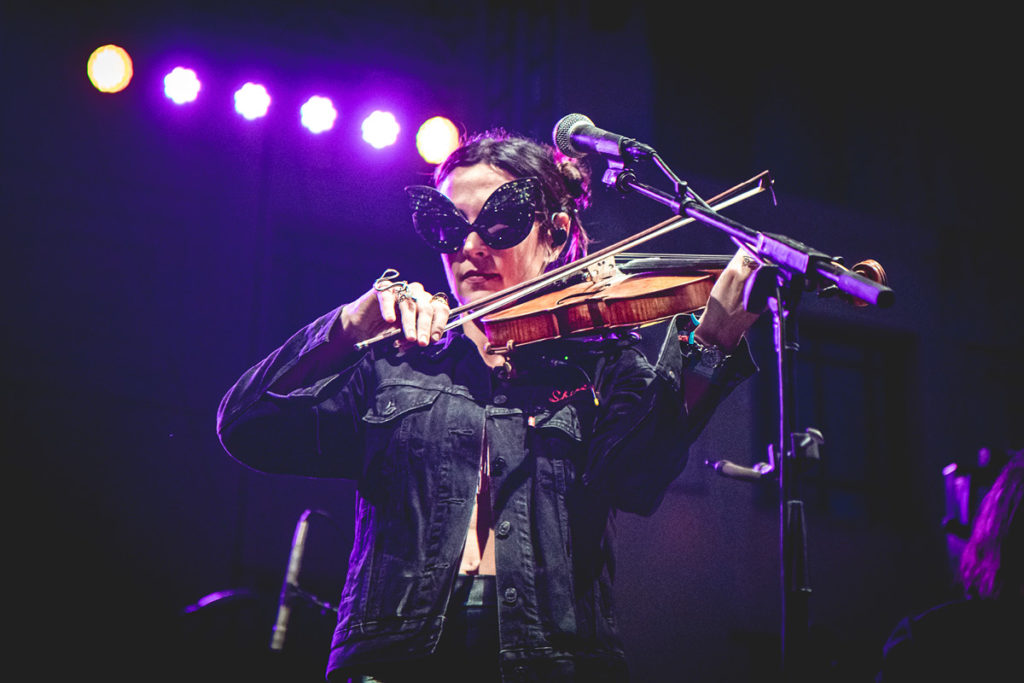 Amanda Shires playing her fiddle and rocking her signature butterfly sunglasses